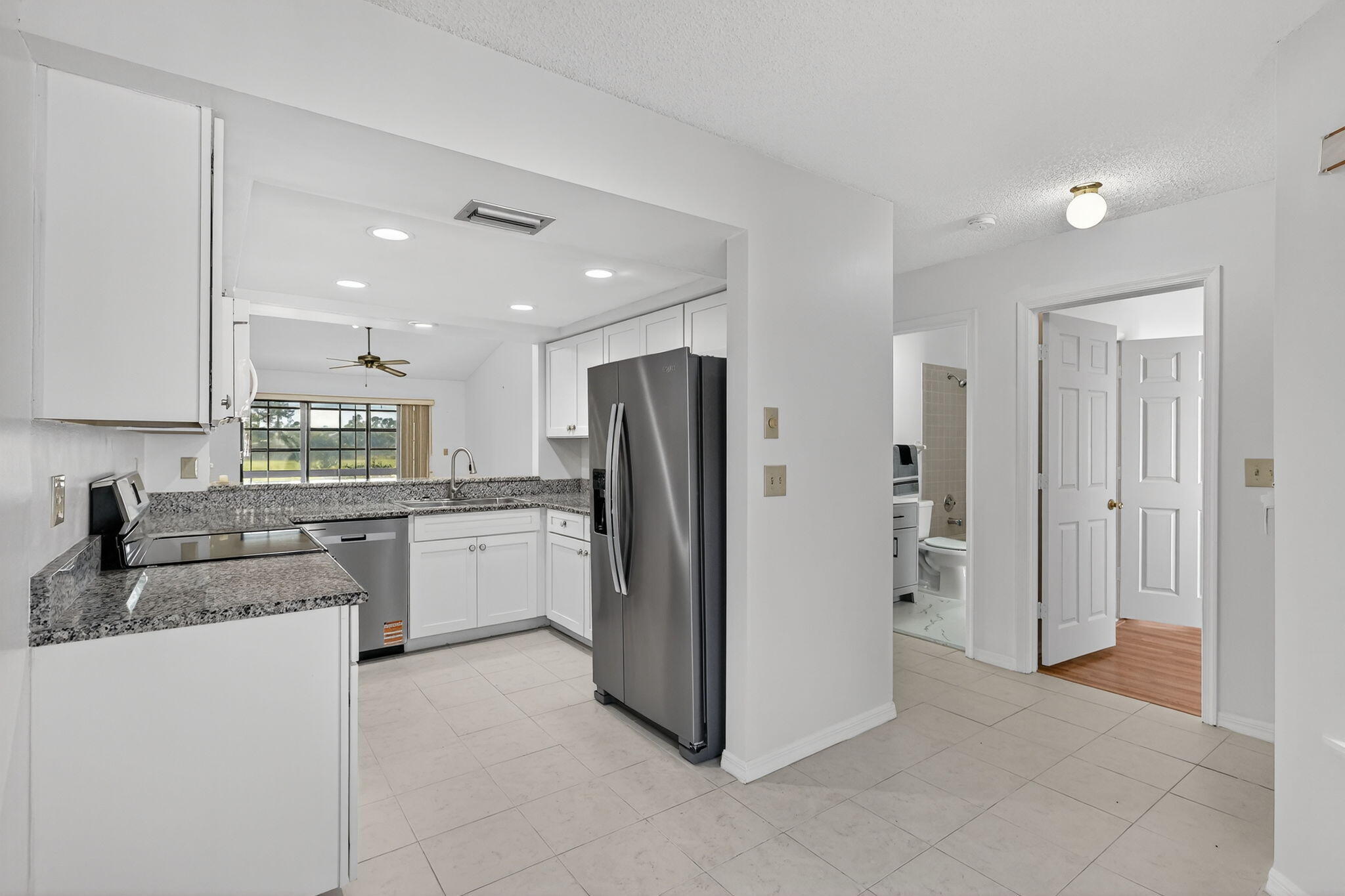 6184 Southeast Georgetown Place Hobe Sound, FL 33455 - Photo 6 of 29 a kitchen with a refrigerator and a sink