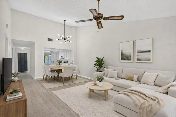 a living room with furniture and a chandelier