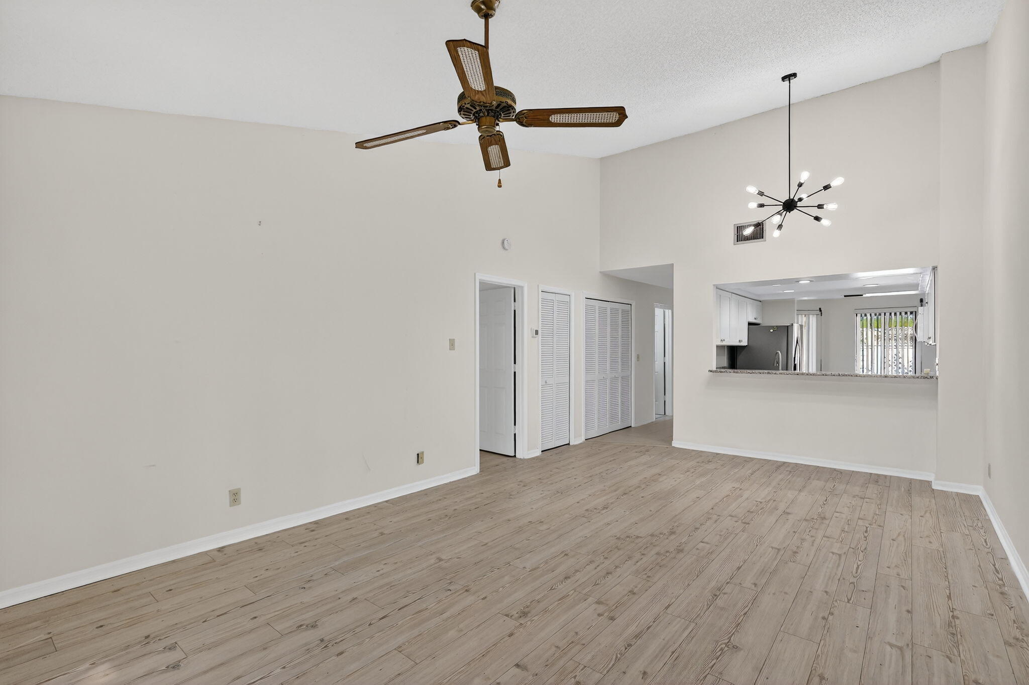 6184 Southeast Georgetown Place Hobe Sound, FL 33455 - Photo 10 of 29 a view of a livingroom with wooden floor and a ceiling fan