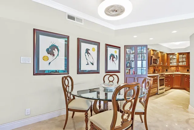 a view of a dining room with furniture and chandelier
