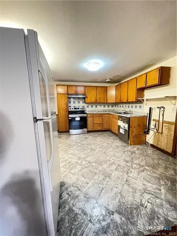 a kitchen with refrigerator and window