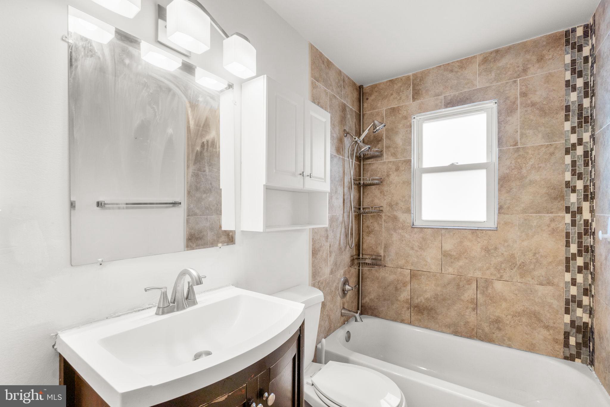 215 Cheddington Road Linthicum Heights, MD 21090 - Photo 21 of 41 a bathroom with a sink toilet tub and shower