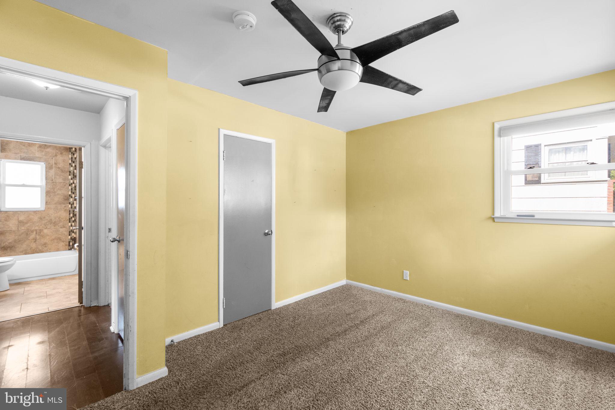 215 Cheddington Road Linthicum Heights, MD 21090 - Photo 23 of 41 a view of a big room with wooden floor and a ceiling fan