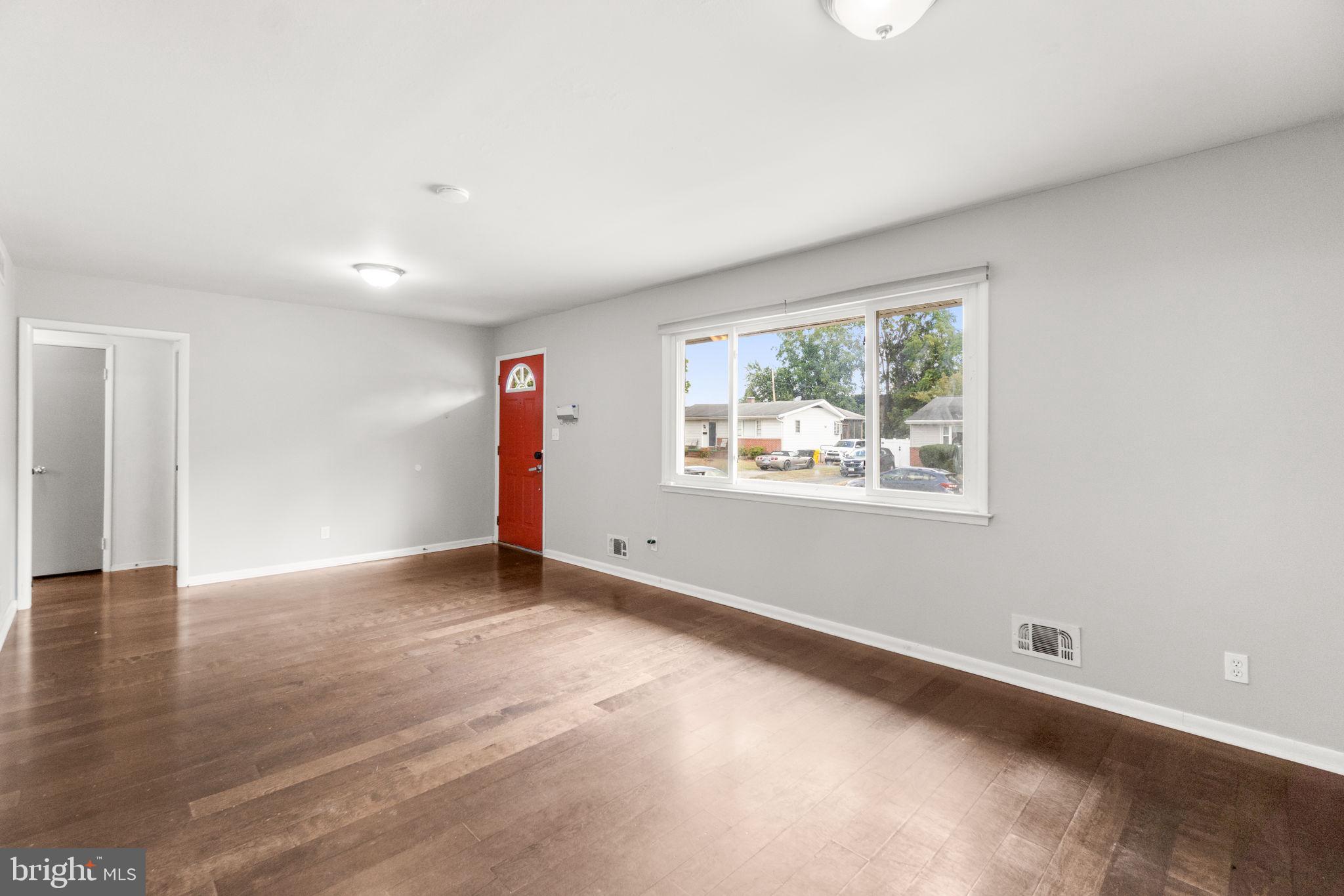 215 Cheddington Road Linthicum Heights, MD 21090 - Photo 6 of 41 an empty room with wooden floor and window