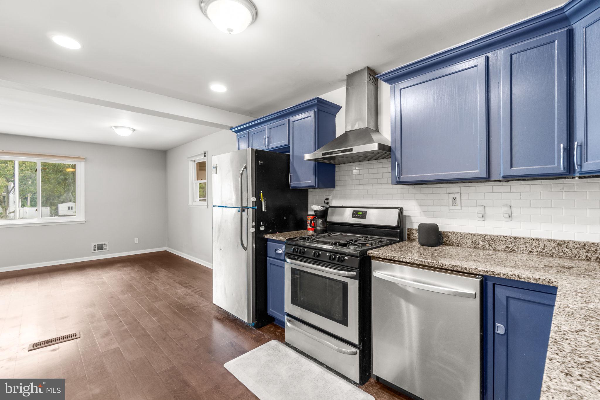 215 Cheddington Road Linthicum Heights, MD 21090 - Photo 10 of 41 a kitchen with stainless steel appliances granite countertop wood cabinets a stove a sink and a refrigerator