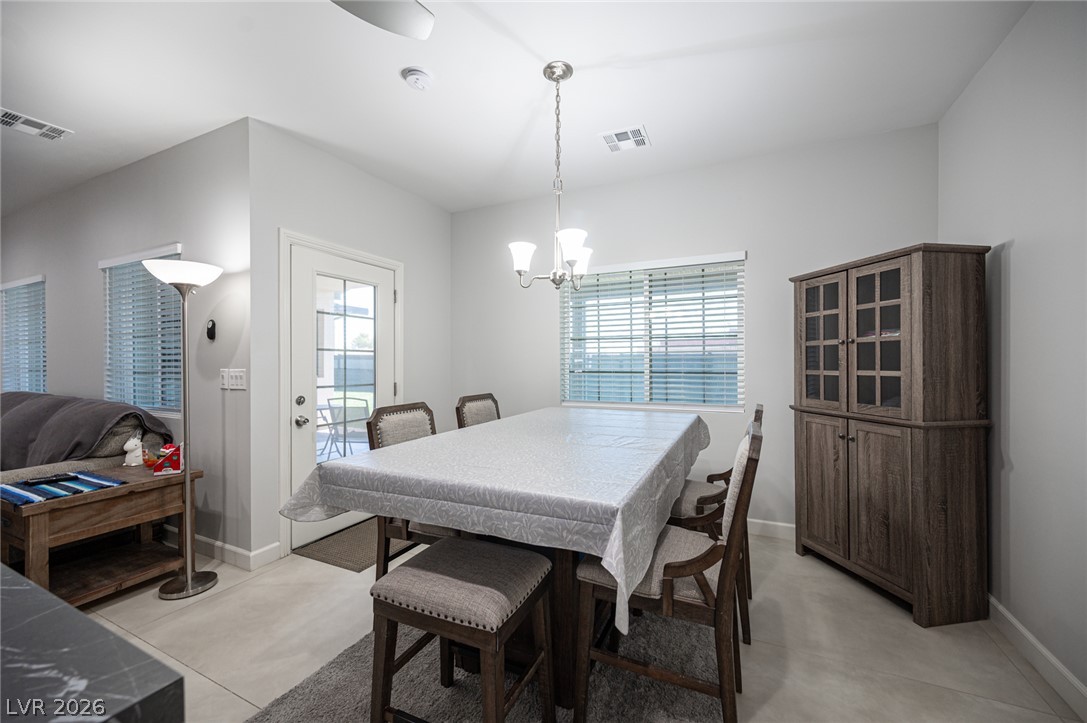 441 Belville Road Pahrump, NV 89048 - Photo 17 of 44 This naturally illuminated dining space features a chandelier and tile flooring.