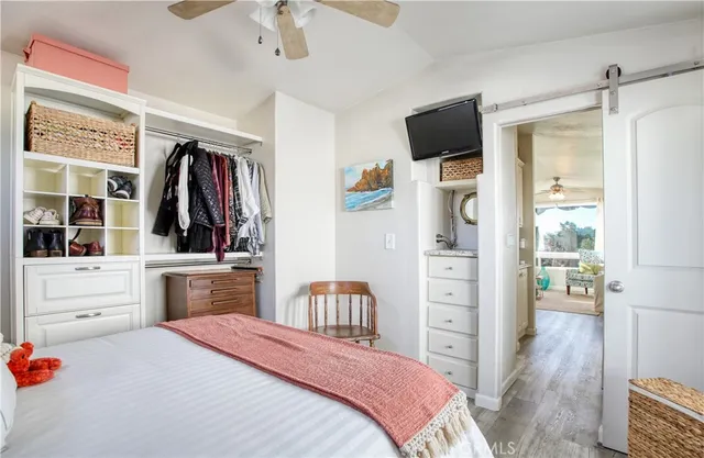 a bedroom with a bed and a large mirror