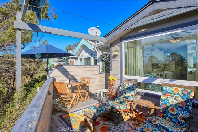 a front view of house with outdoor seating and wooden floor