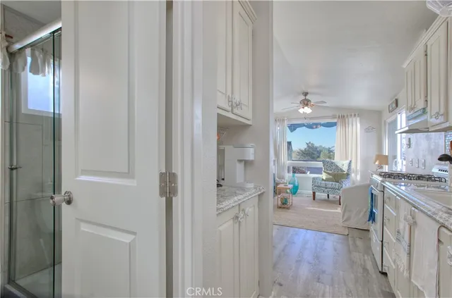 a kitchen with stainless steel appliances granite countertop cabinets and wooden floor