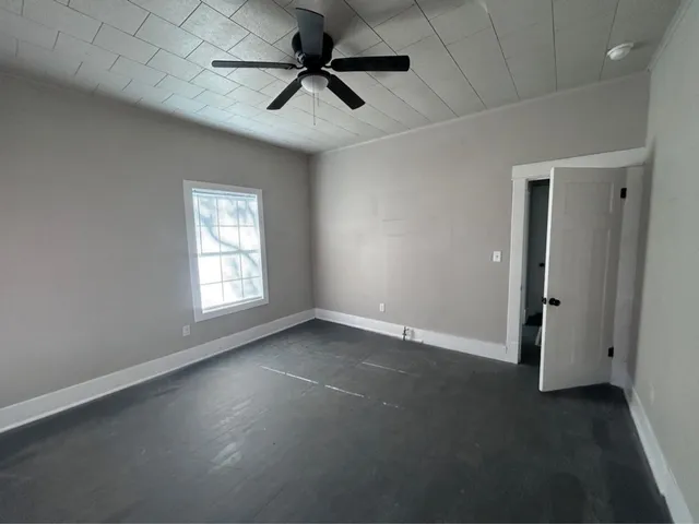 an empty room with a empty space and a ceiling fan
