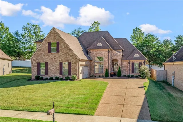 a front view of house with yard and green space