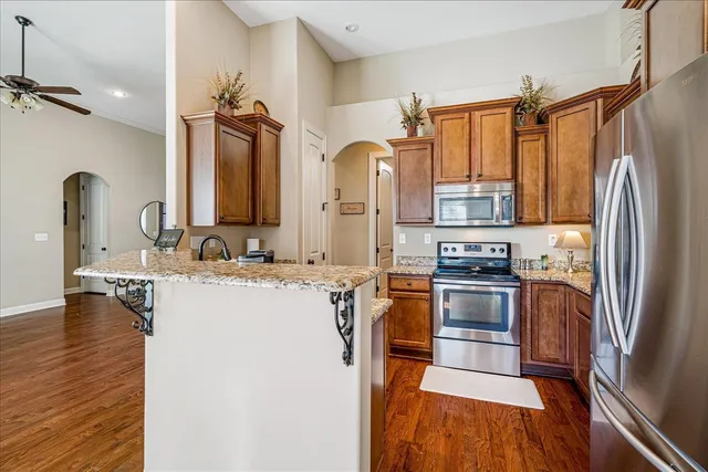 a kitchen with stainless steel appliances a refrigerator sink and stove