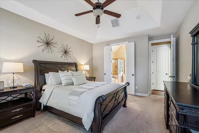 a bedroom with a bed and a chandelier