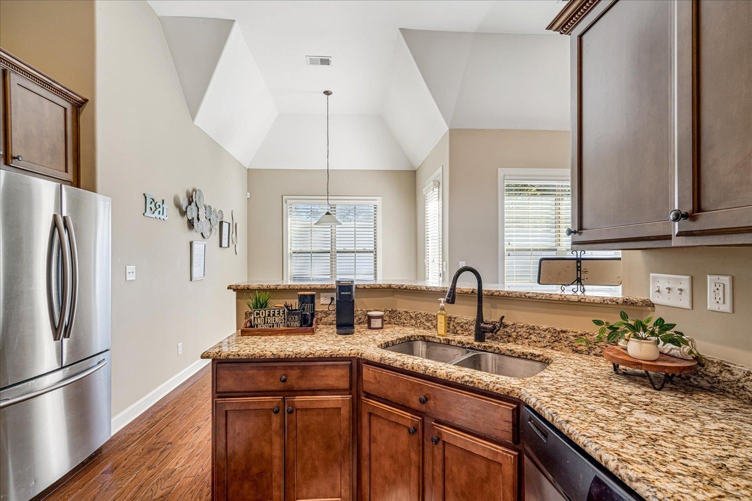 3230 Brunswick View Cove Bartlett, TN 38133 - Photo 19 of 32 Kitchen with stainless steel appliances, a peninsula, light stone counters, and dark wood-style floors