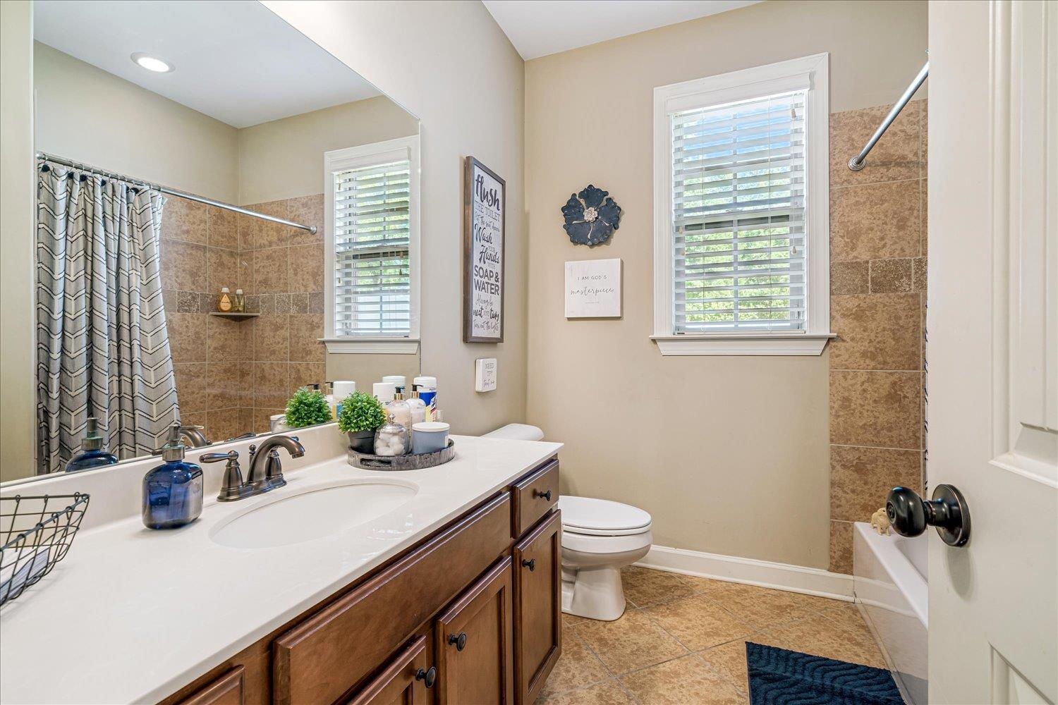 3230 Brunswick View Cove Bartlett, TN 38133 - Photo 22 of 32 Bathroom featuring vanity, light tile patterned floors, and shower / tub combo