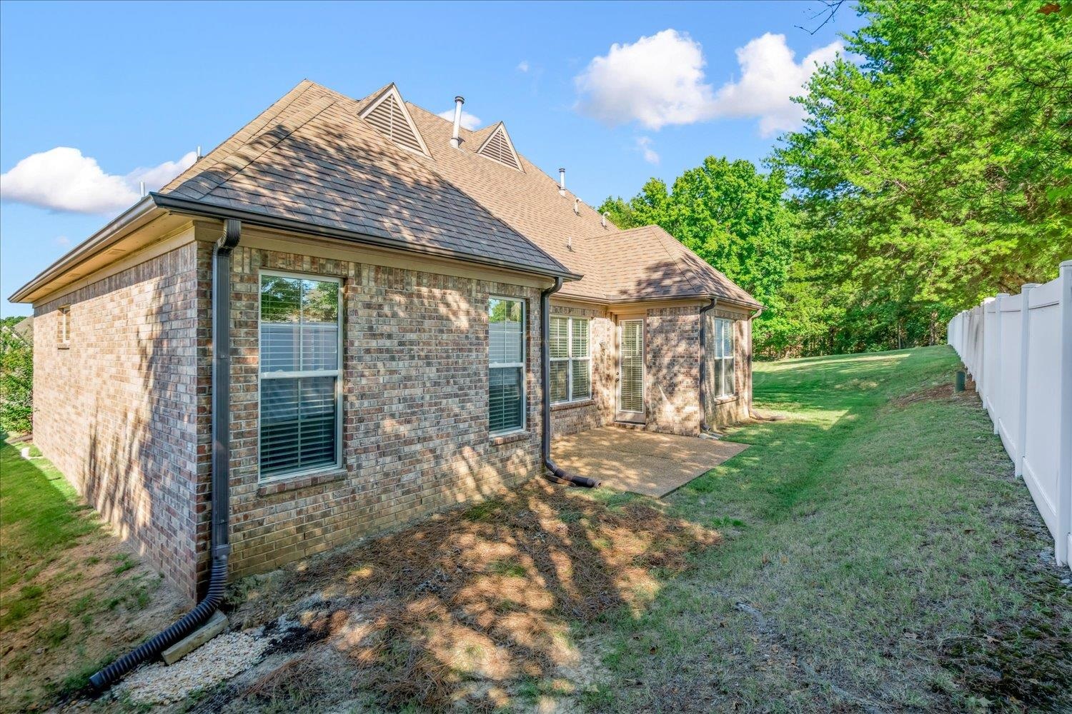 3230 Brunswick View Cove Bartlett, TN 38133 - Photo 23 of 32 View of side of property with a shingled roof, brick siding, and a patio area