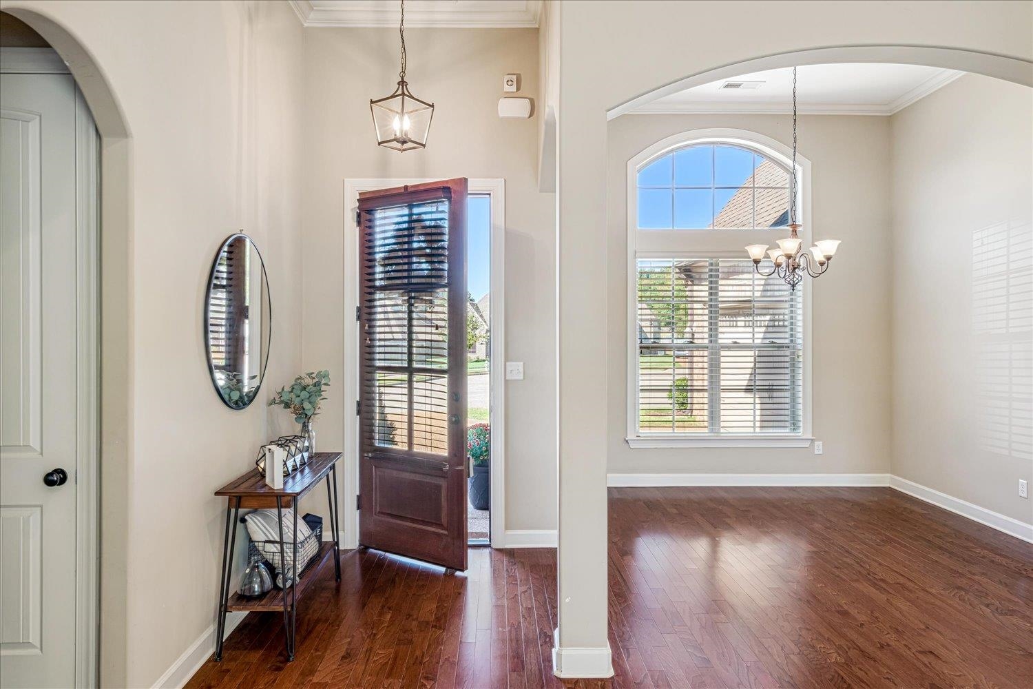 3230 Brunswick View Cove Bartlett, TN 38133 - Photo 3 of 32 Foyer with arched walkways, a chandelier, ornamental molding, and dark wood-style flooring