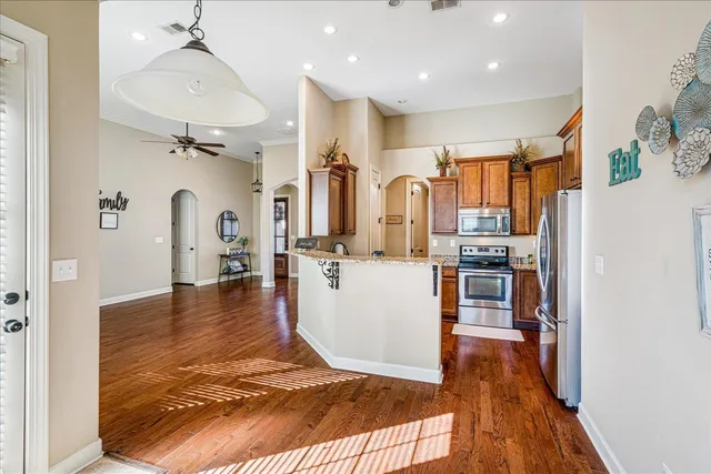 a view of a kitchen with furniture and wooden floor