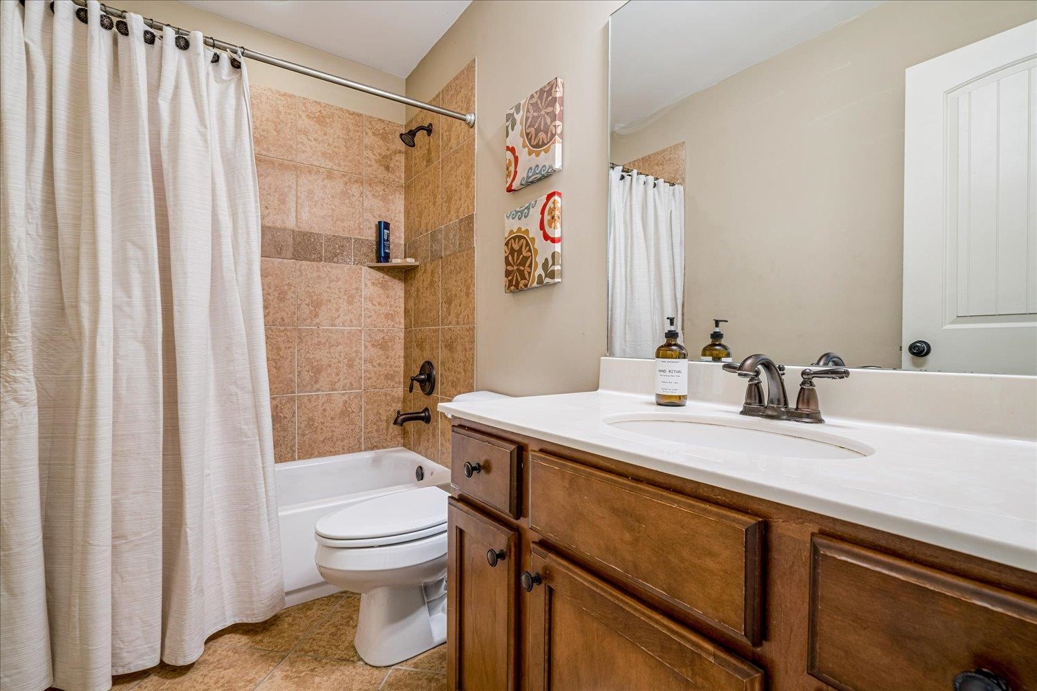 3230 Brunswick View Cove Bartlett, TN 38133 - Photo 30 of 32 Full bathroom with shower / bath combination with curtain, vanity, and light tile patterned floors