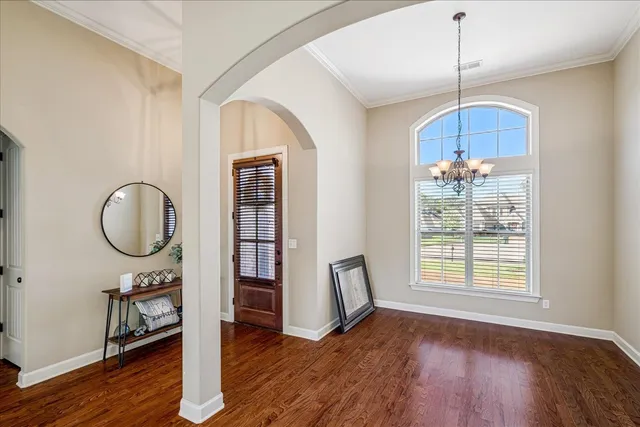 a view of a room with wooden floor and window