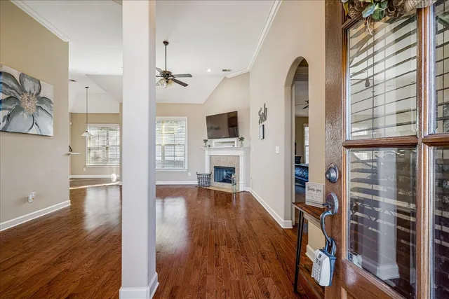 a view of empty room with wooden floor and fireplace