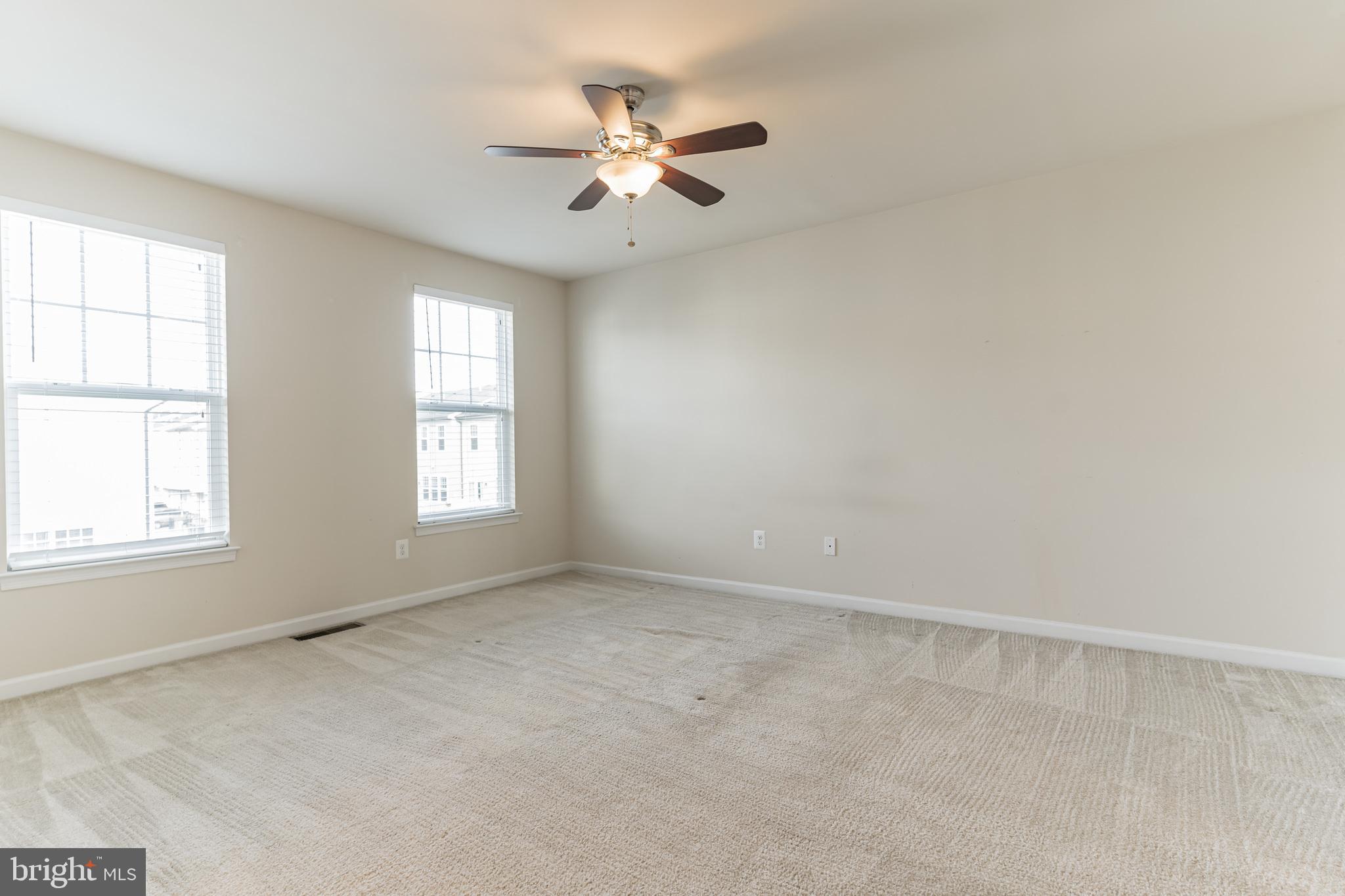 25621 Pleasant Valley Road Chantilly, VA 20152 - Photo 16 of 52 an empty room with windows and fan