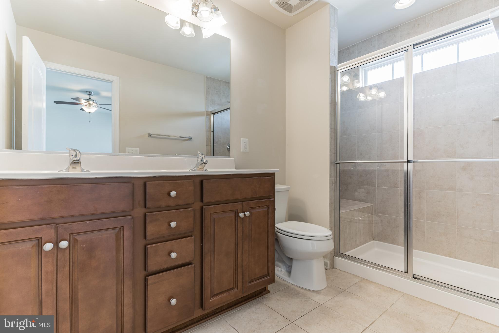 25621 Pleasant Valley Road Chantilly, VA 20152 - Photo 18 of 52 a bathroom with a sink toilet and shower