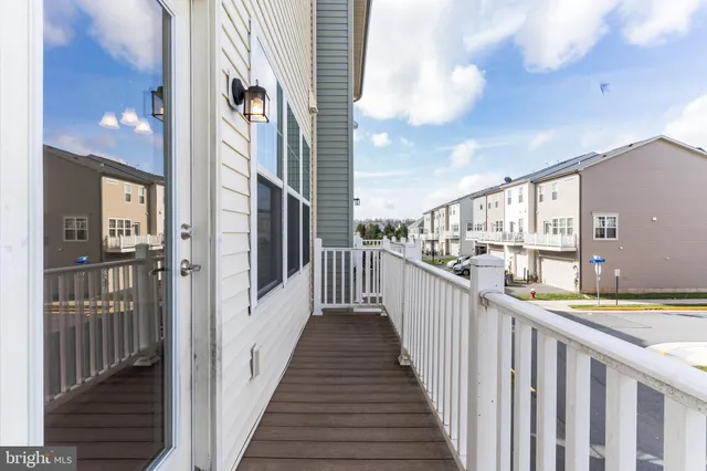 a view of a balcony with furniture and wooden floor