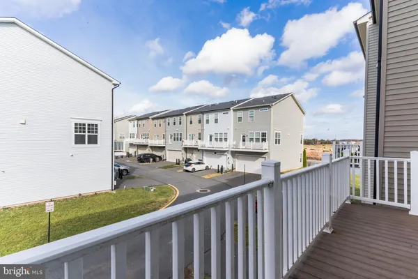 a kitchen with stainless steel appliances granite countertop a refrigerator a sink and white cabinets