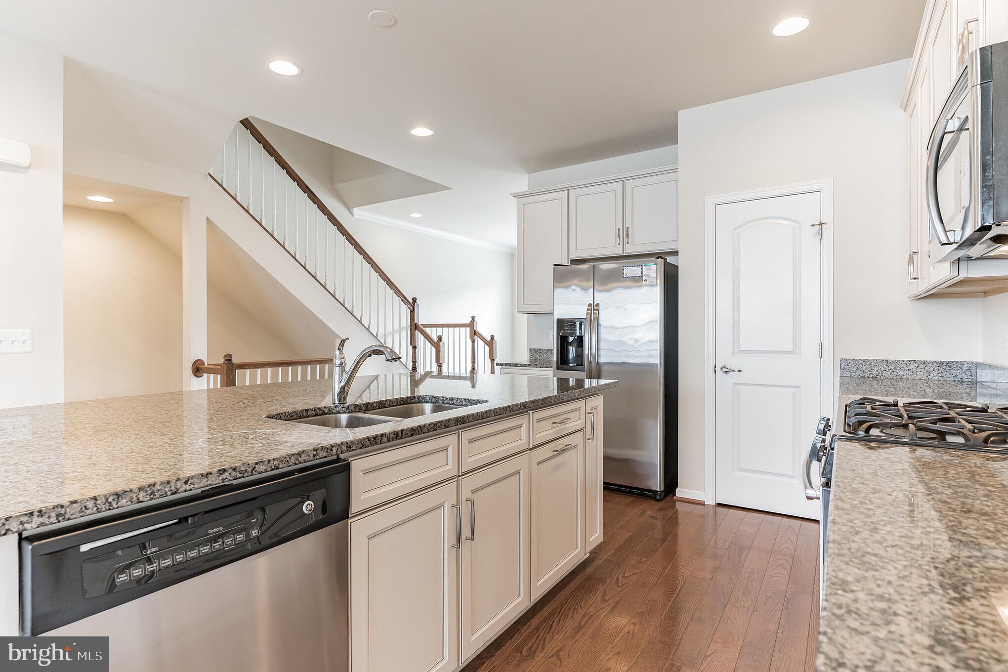 25621 Pleasant Valley Road Chantilly, VA 20152 - Photo 25 of 52 a kitchen with stainless steel appliances granite countertop a refrigerator a sink and white cabinets