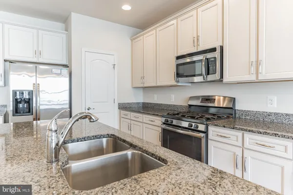a kitchen that has a sink and a stove
