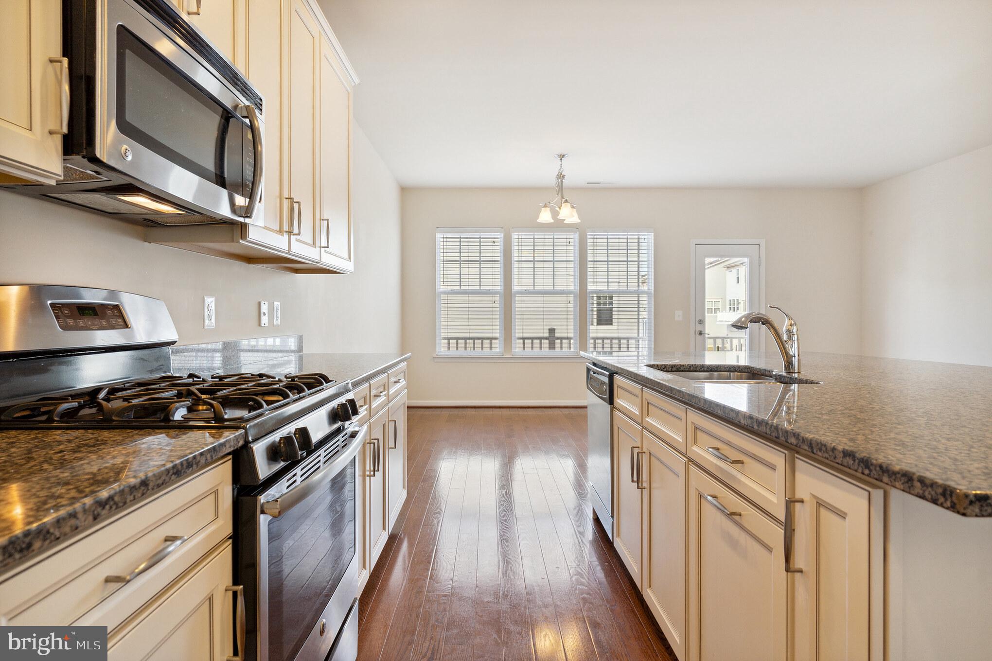 25621 Pleasant Valley Road Chantilly, VA 20152 - Photo 29 of 52 a kitchen with stainless steel appliances granite countertop a stove and a sink