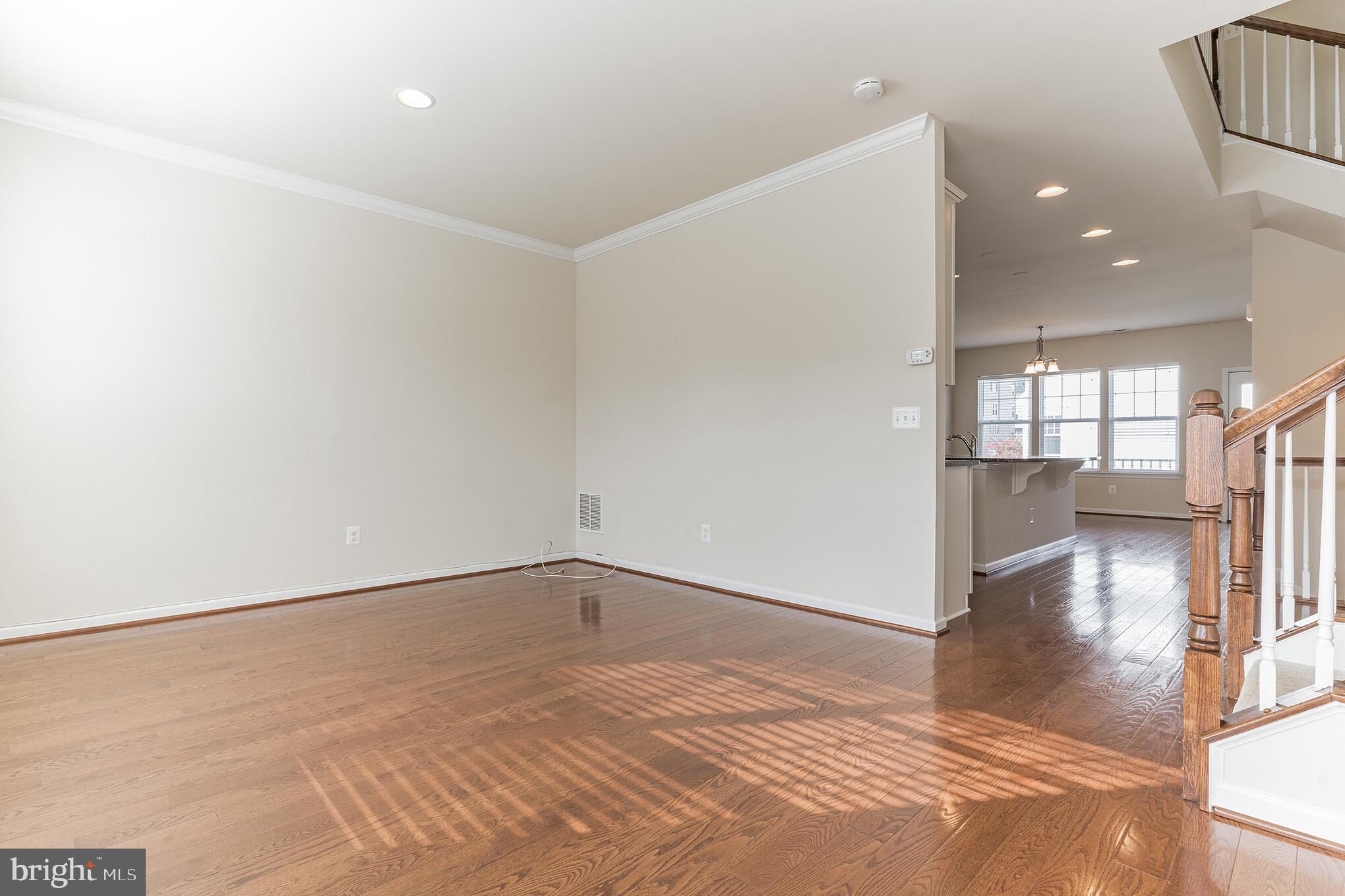 25621 Pleasant Valley Road Chantilly, VA 20152 - Photo 33 of 52 an empty room with wooden floor and a bathroom
