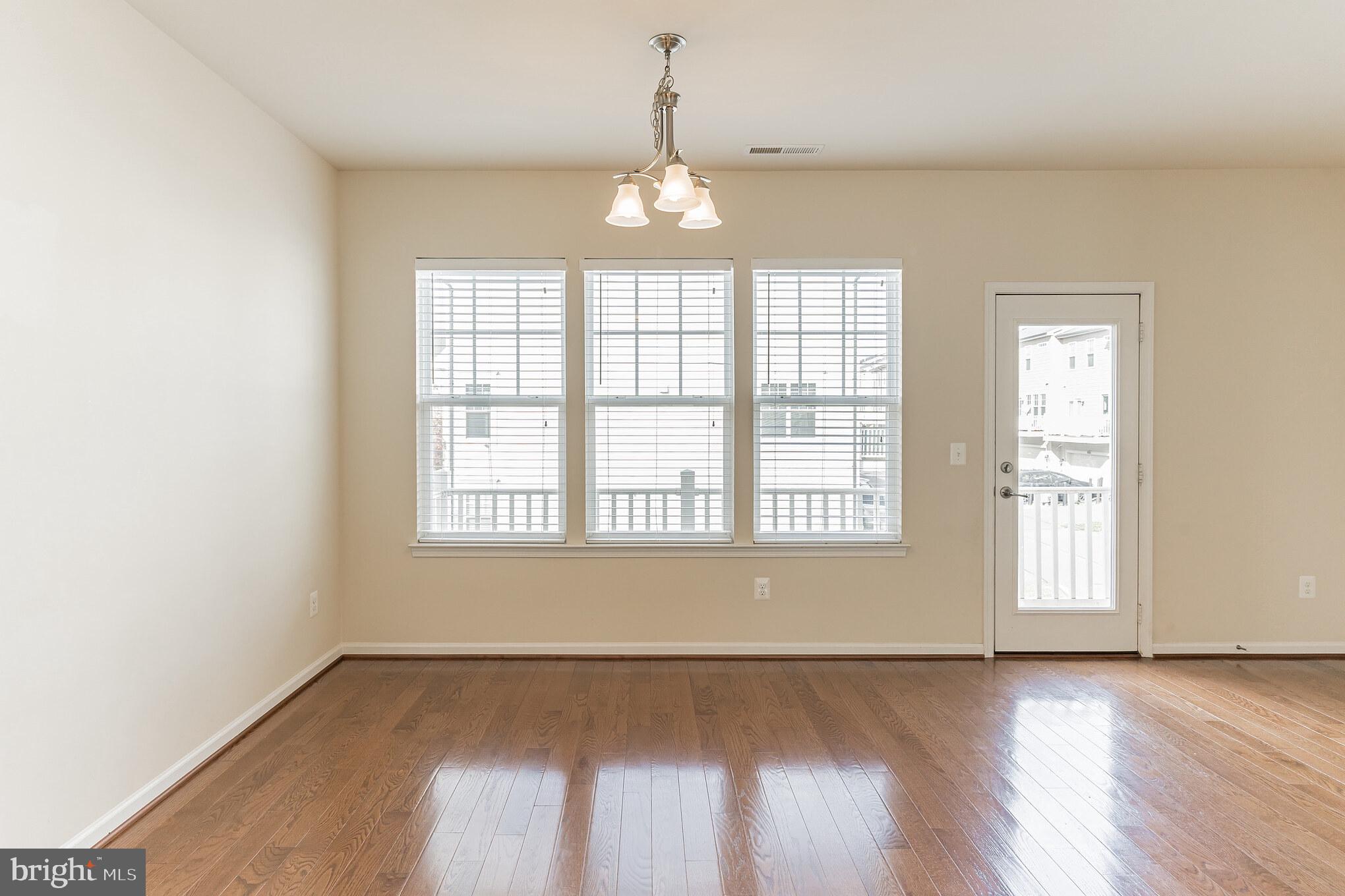 25621 Pleasant Valley Road Chantilly, VA 20152 - Photo 36 of 52 an empty room with wooden floor and windows