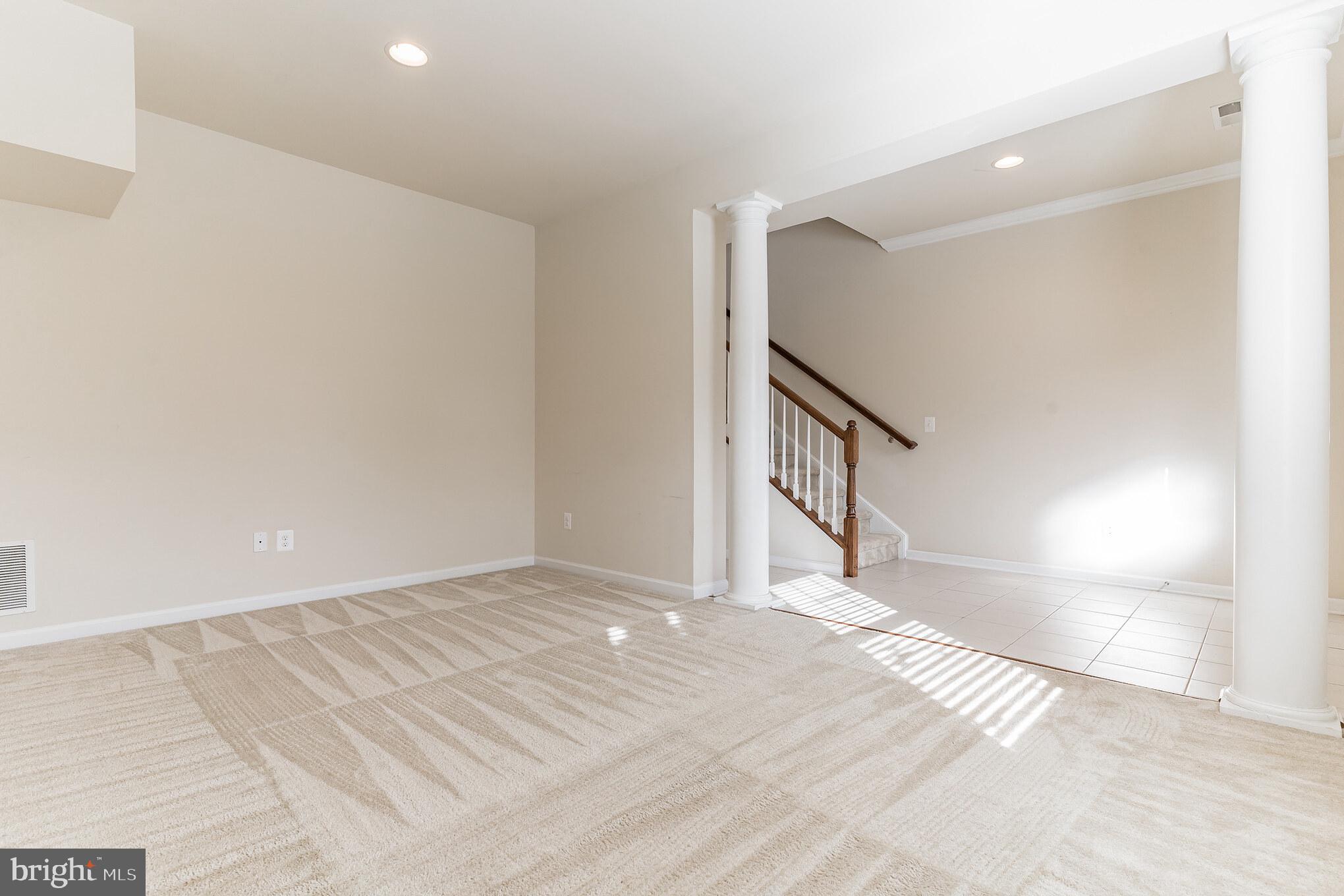 25621 Pleasant Valley Road Chantilly, VA 20152 - Photo 41 of 52 a view of an empty room with stairs and a window