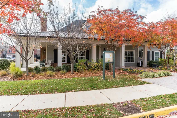 a view of a porch with a table and chairs under an umbrella
