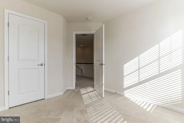 a view of an empty room and a window