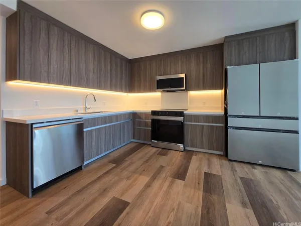 a kitchen with wooden cabinets and stainless steel appliances