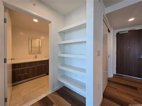 a view of an empty walk in closet and bedroom view