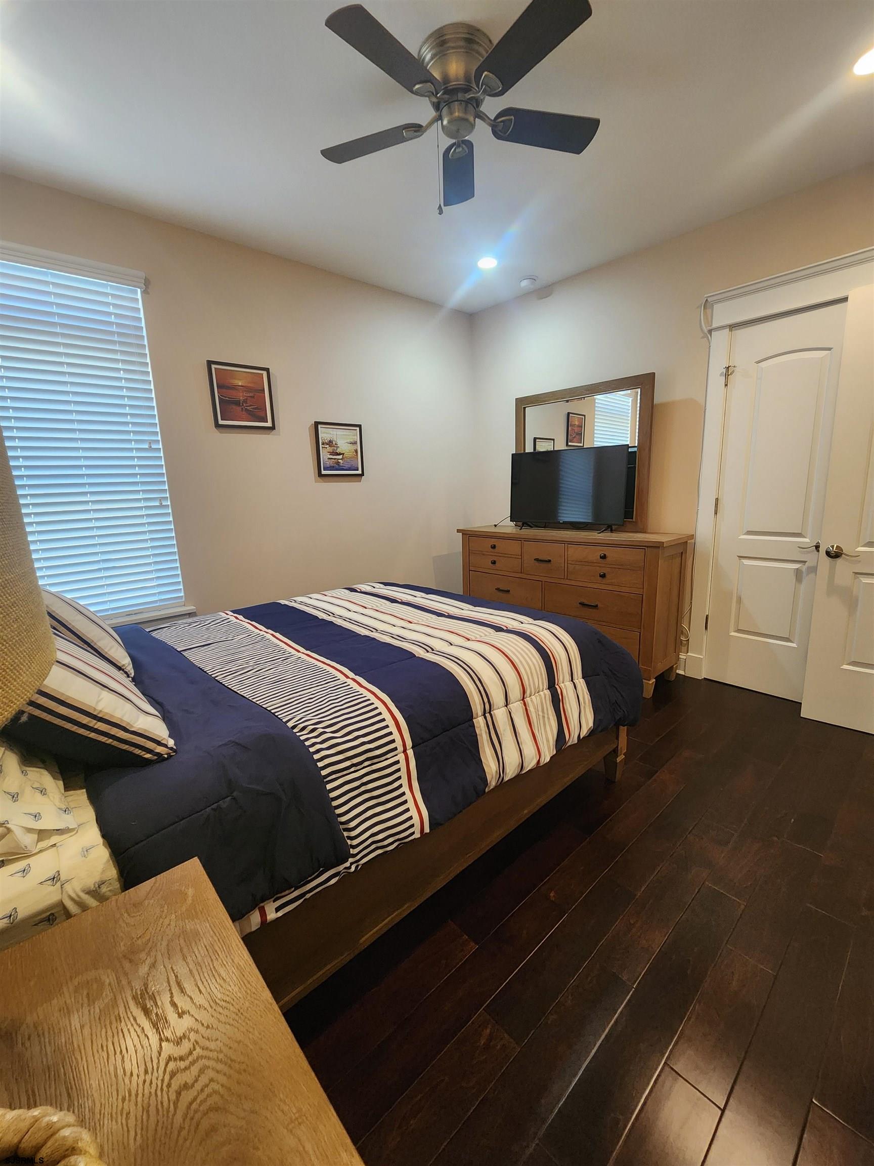 16 North Decatur Avenue, Unit 1 Margate City, NJ 08402 - Photo 14 of 29 a bedroom with a bed and ceiling fan