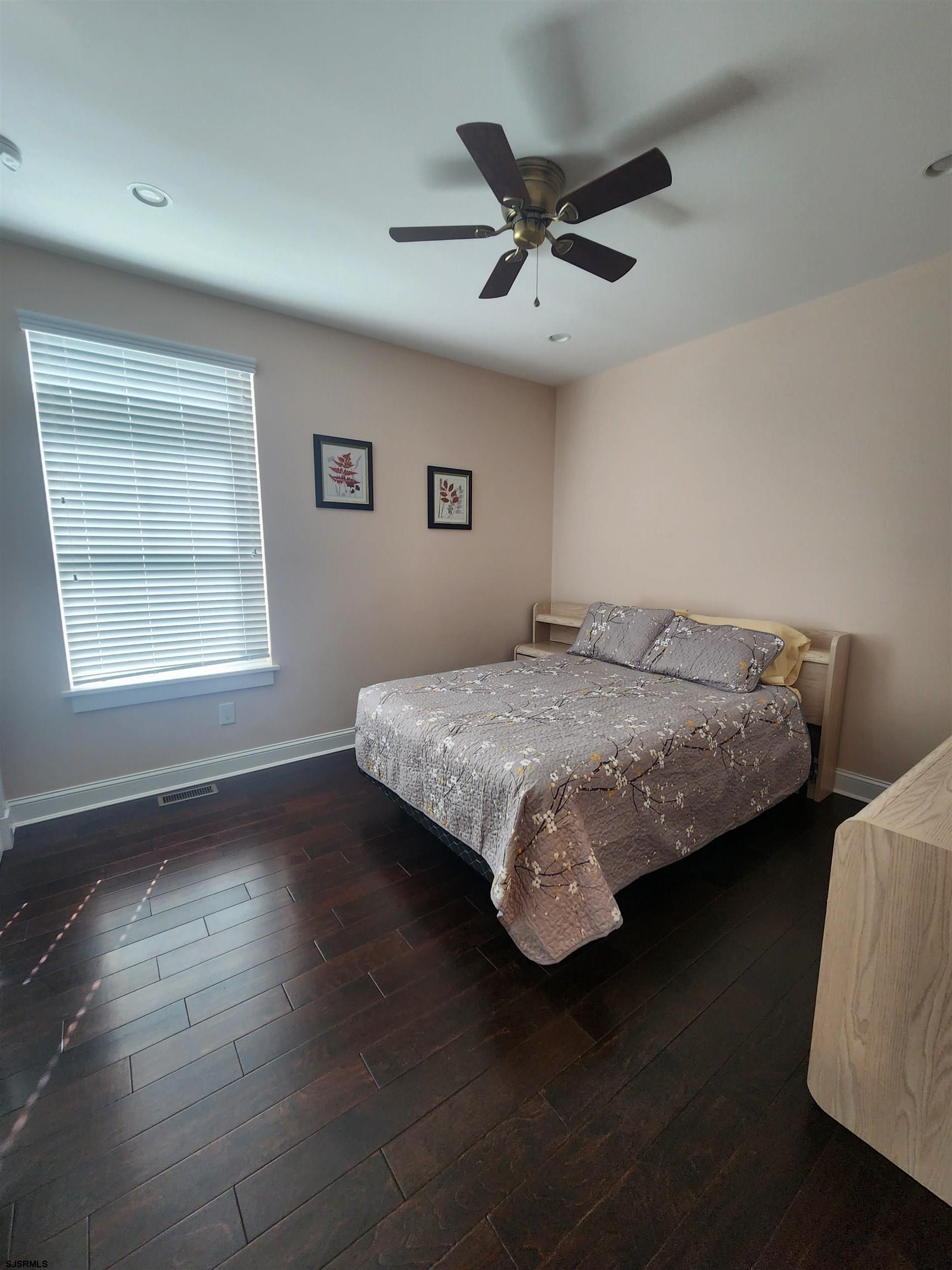 16 North Decatur Avenue, Unit 1 Margate City, NJ 08402 - Photo 15 of 29 a bedroom with a bed and wooden floor