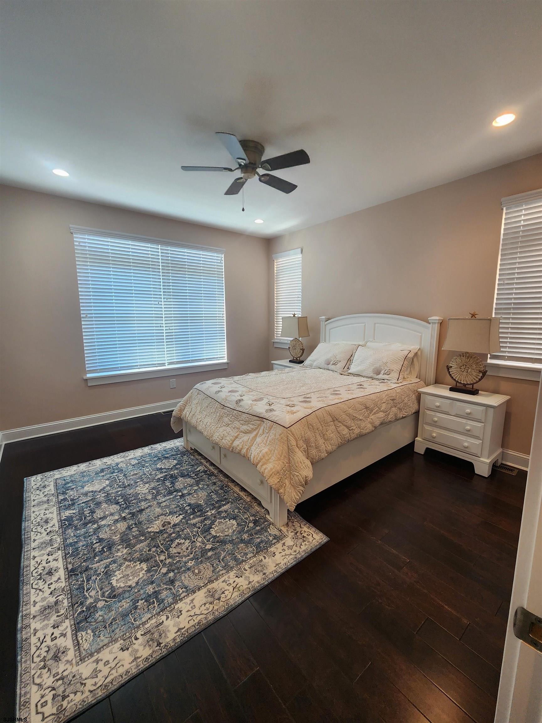 16 North Decatur Avenue, Unit 1 Margate City, NJ 08402 - Photo 17 of 29 a bedroom with a large bed and a flat tv screen on dresser