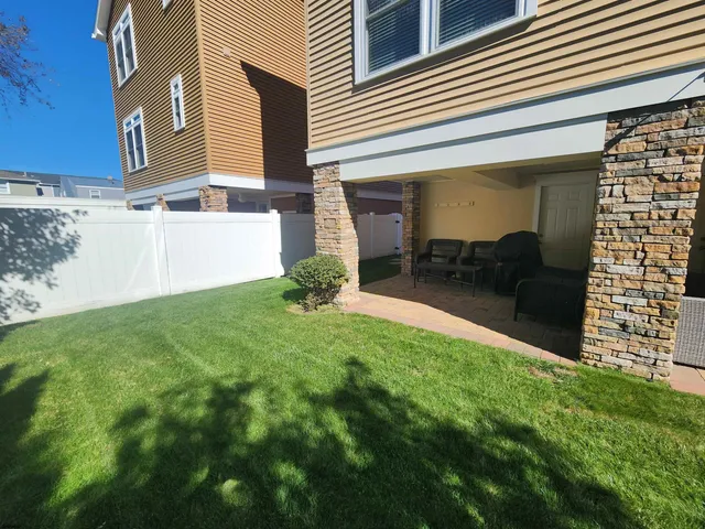 a backyard of a house with table and chairs