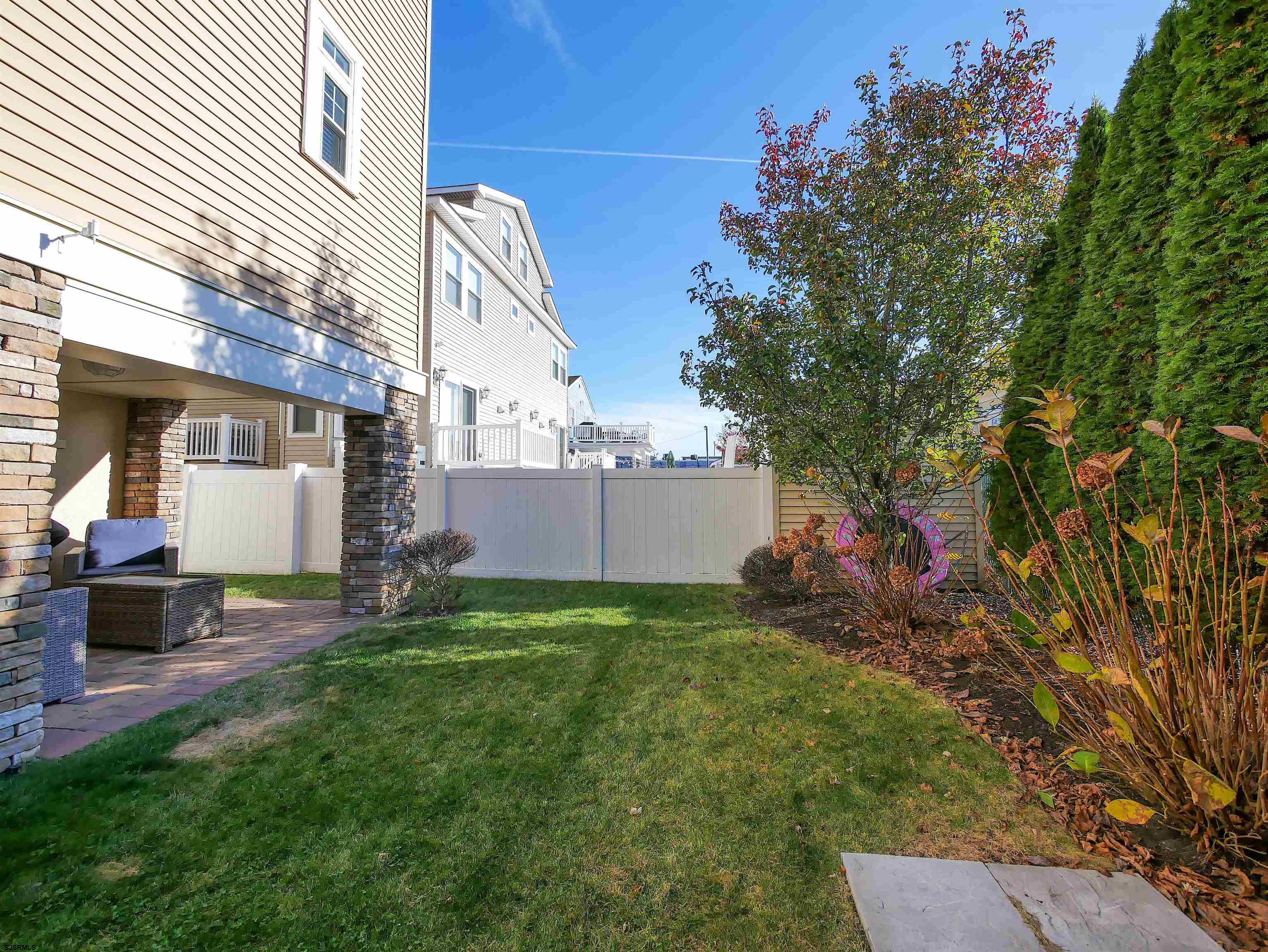16 North Decatur Avenue, Unit 1 Margate City, NJ 08402 - Photo 27 of 29 a backyard of a house with table and chairs