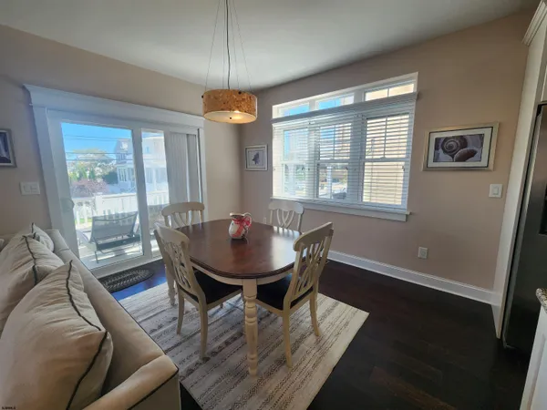 a view of a dining room with furniture wooden floor and chandelier
