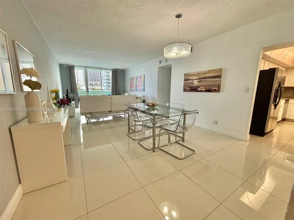 a living room with patio furniture and a flat screen tv