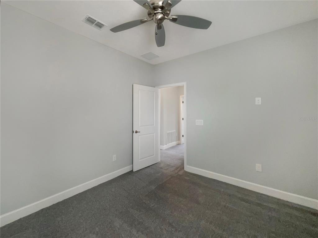 705 Winterside Drive Apollo Beach, FL 33572 - Photo 18 of 30 en empty room with window and ceiling fan