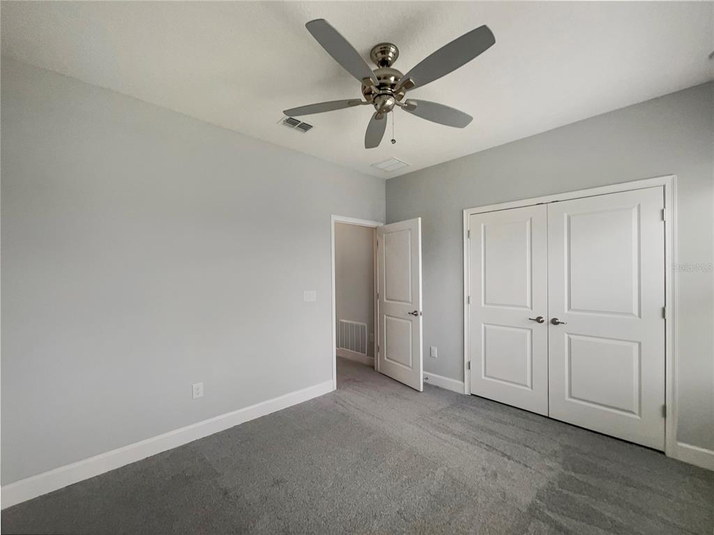 705 Winterside Drive Apollo Beach, FL 33572 - Photo 19 of 30 an empty room with closet and a chandelier fan