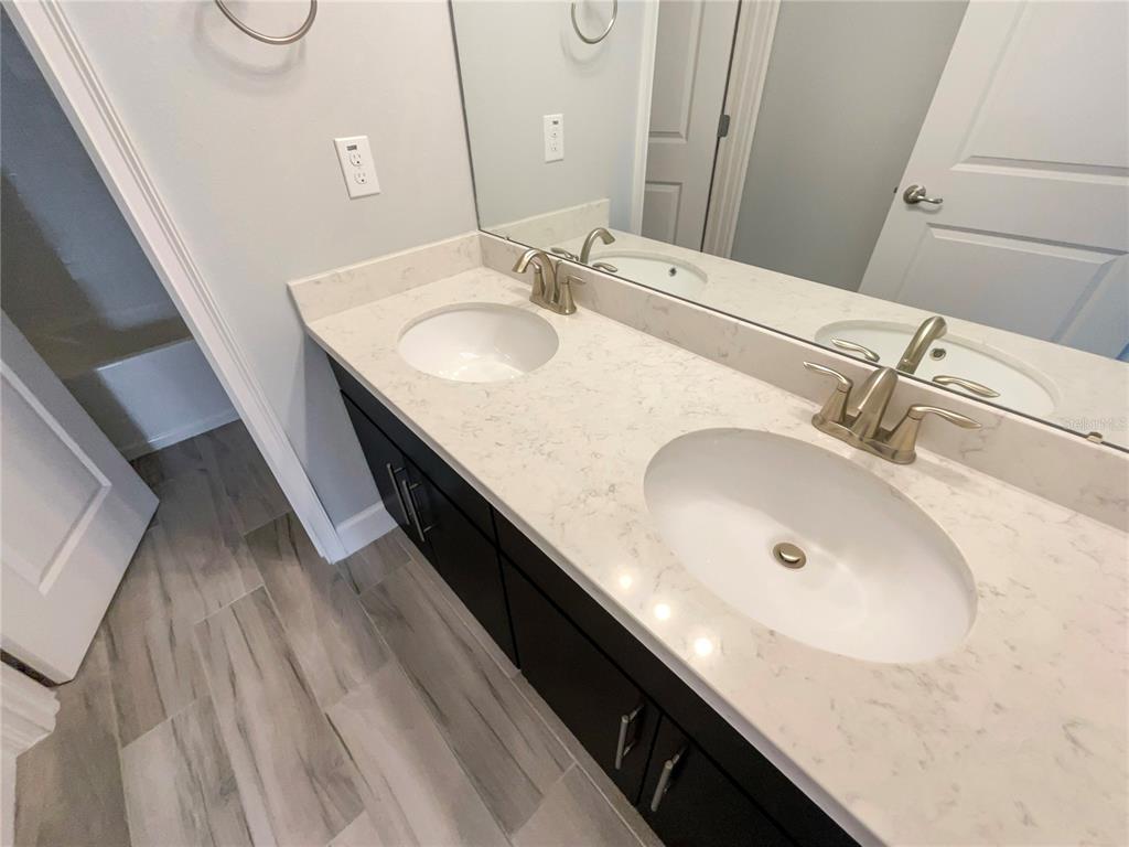 705 Winterside Drive Apollo Beach, FL 33572 - Photo 20 of 30 a bathroom with a double vanity sink and a mirror