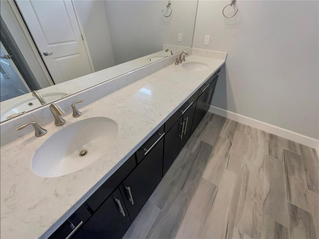 705 Winterside Drive Apollo Beach, FL 33572 - Photo 23 of 30 a bathroom with a double vanity sink and mirror